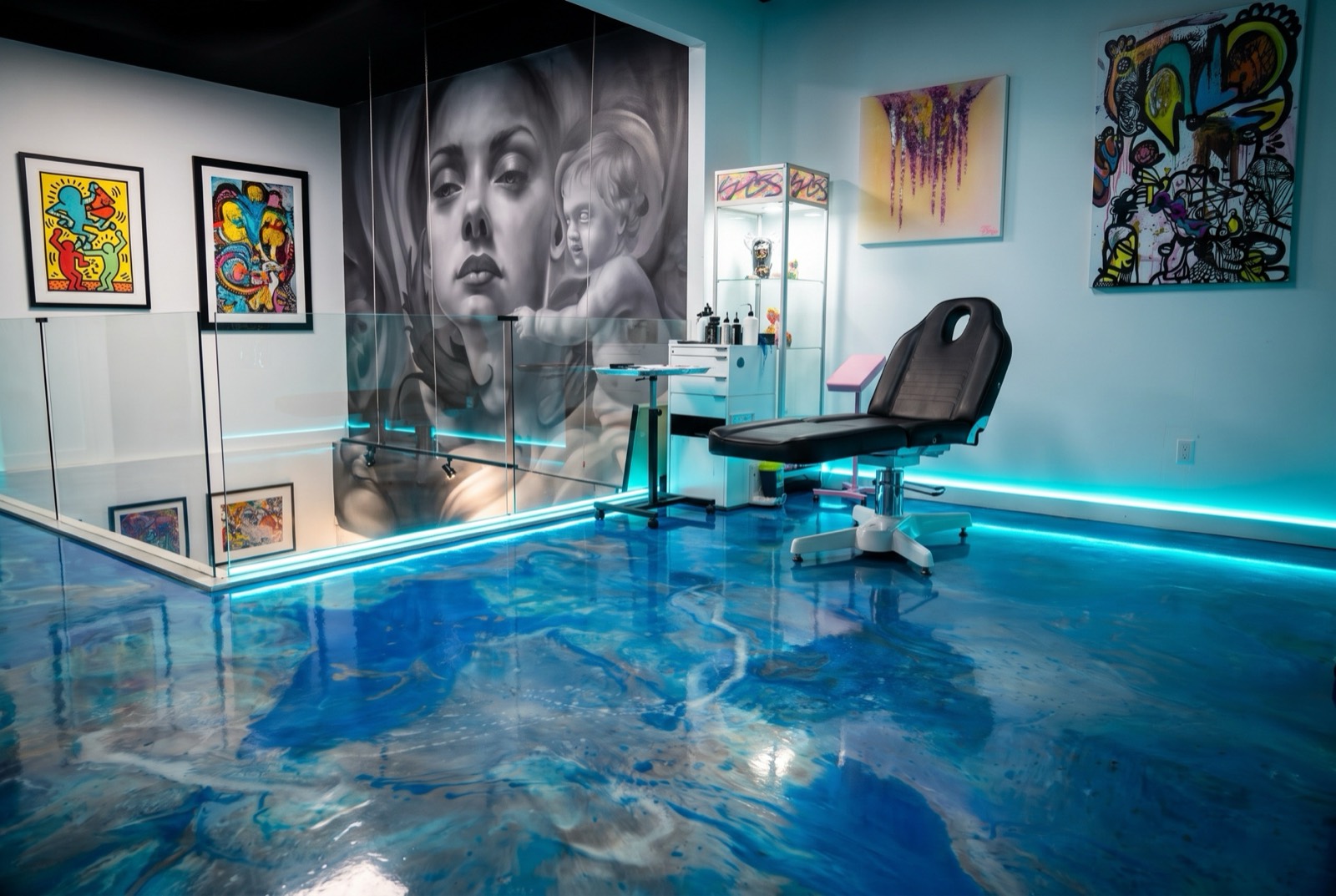 Inside Yes Electric Tattoo — blue resin floor, mural wall and tattoo station