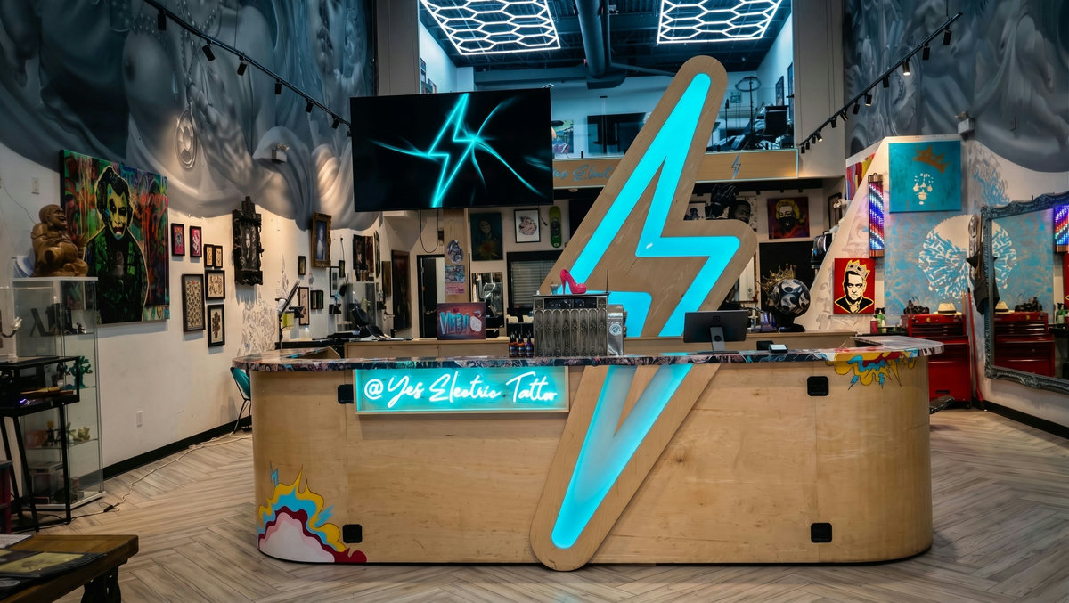 Wide view of the Yes Electric tattoo studio loft, ceiling lights and flash art